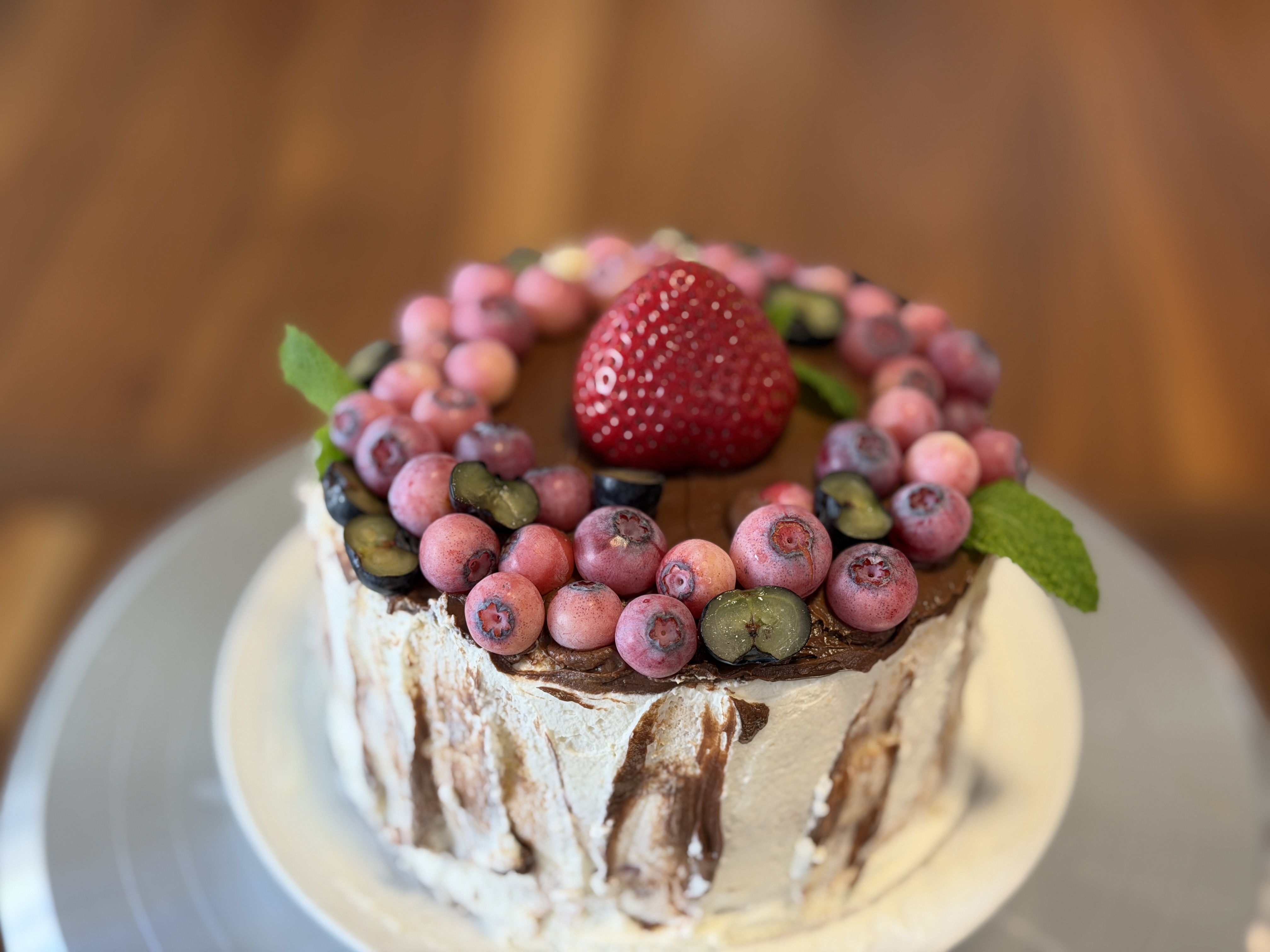 Berry-topped cake with strawberry and mint
